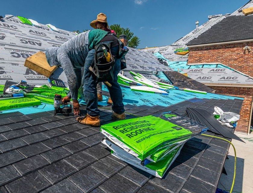 Roofer with shingle bundles