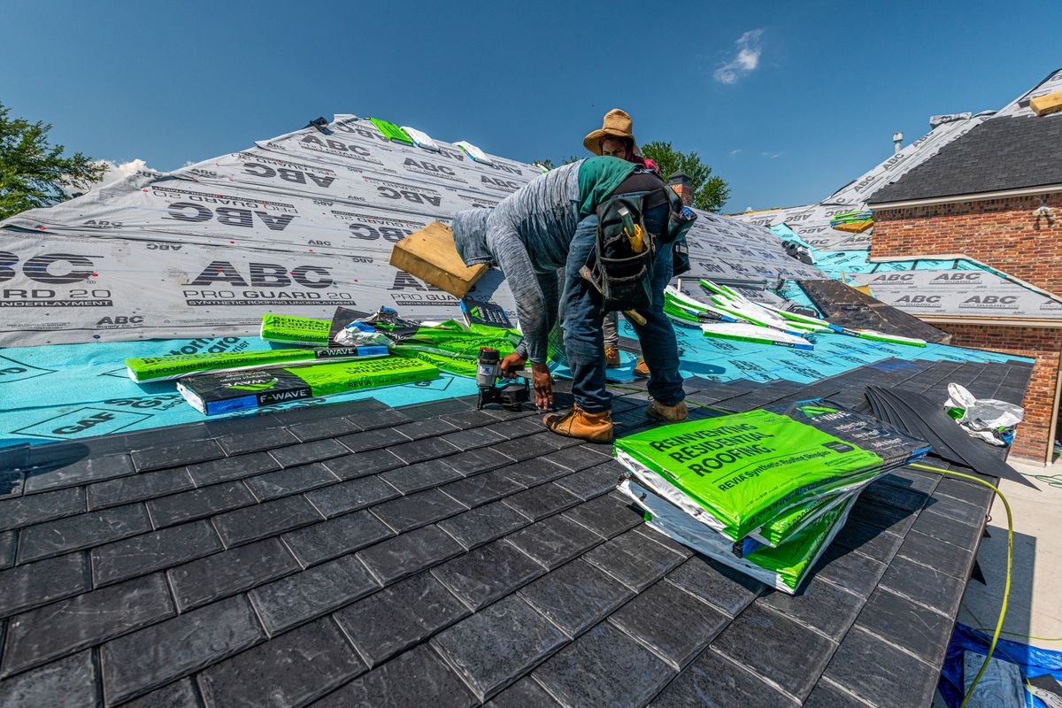 Roofer installing shingles with underlayment
